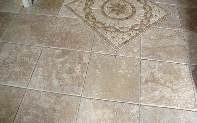 a bathroom with a toilet and a tile floor