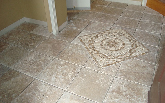 a bathroom with a toilet and a tile floor