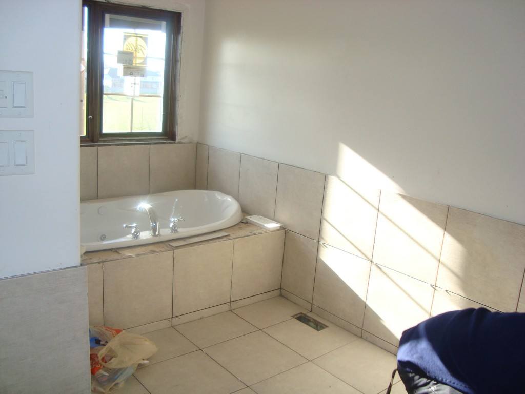a bathroom with a bath tub and a window