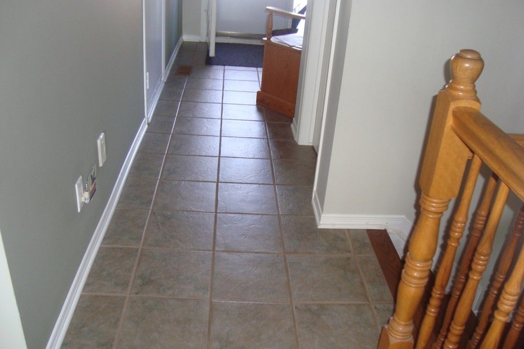 white wooden door on brown ceramic floor tiles