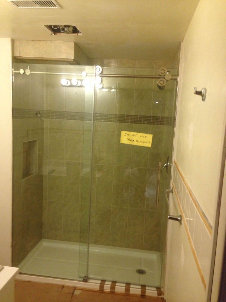clear glass shower stall near white wall