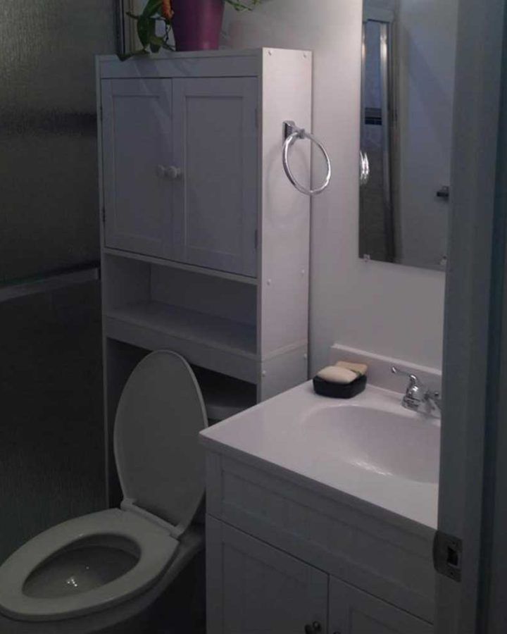 a white toilet next to a white sink