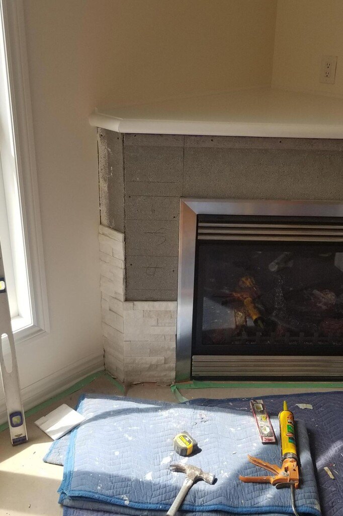 a fire place with a blanket and tools on it