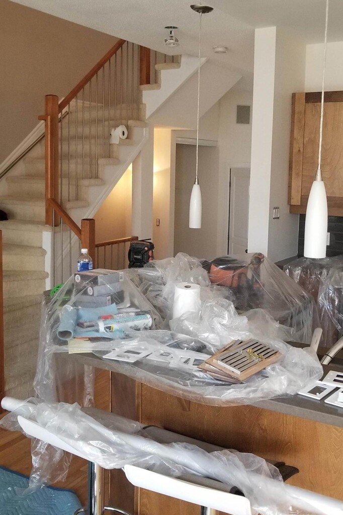 a kitchen with a lot of clutter on the counter